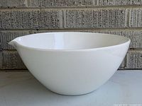 side profile of white John Julian mixing bowl showing shape and spout
