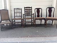 Front view of all five chairs lined up to show overall styles and condition