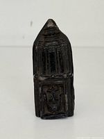 Front view showing full figurine and relief panel