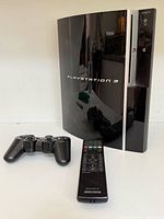 PlayStation 3 console front with controller and remote