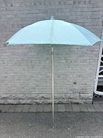 Full umbrella side view against wall