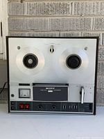 Front view of Sony TC-352D showing reels, controls, and faceplate.