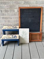 Group shot showing chalkboard, step stool and relief panel