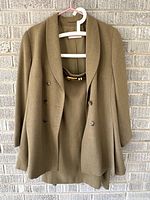 Blazer and skirt on hangers showing overall style and color