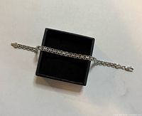 Bracelet displayed across black jewellery box