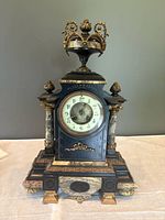 Front view of ornate French slate and marble mantel clock