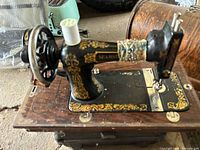 Full view of sewing machine showing decals, base, and crank