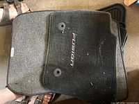 Stack of carpet floor mats with Fusion logo
