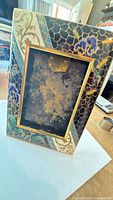 Rear view of rectangular cloisonné enamel frame showing easel back and overall size
