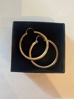 Pair of gold hoop earrings in box