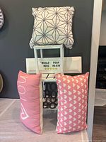Overall view showing three pillows, letter board, shelf, trivets
