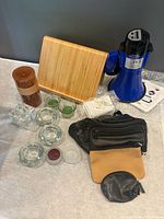 Group shot of megaphone, bamboo board, candles, holders, pouches