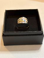 Domed sterling silver ring in black box, front view