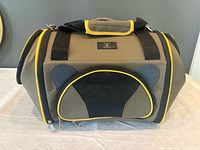 front view showing mesh window, yellow trim, handles