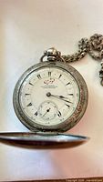 Open watch showing Arabic dial and subsidiary seconds