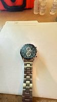 Front view of stainless steel quartz chronograph watch on folder background
