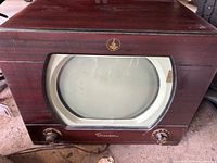 Front view of Emerson television showing round CRT, wood cabinet and control knobs