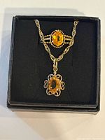 Ring and pendant necklace displayed in box