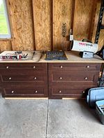 Two brown cabinets, HeatStar heater, driver bit set, clamps and tools visible
