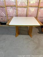 Full view of wooden crafts table with white laminate top and pedestal legs
