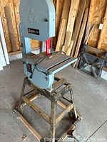 Full view of Delta band saw mounted on metal stand