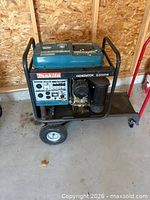 Full view of Makita G5501R generator on wheeled cart showing control panel, fuel tank and frame