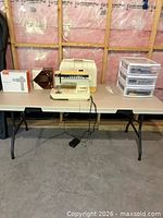 Overall view of sewing machine, accessories, drawer unit and folding table