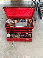 Overall view of red toolbox with open drawers and contents