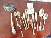 All 13 flatware and serving pieces laid out