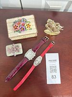 All items overview: two wristwatches, two ceramic trinket boxes, gold-tone bear figurine