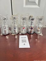 Five wrapped mini Stanley Cup trophies lined on table
