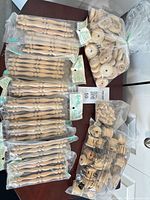 Overview of all sealed bags of spindles, wheels, bobbins and knobs on table