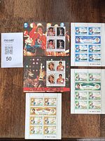 All five stamp sheets laid out on table