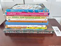 Full stack of 10 books side view