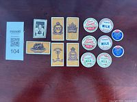 Overview of all cigarette cards and bottle caps laid out on table