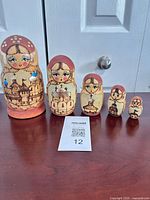 Front view of all five nesting dolls lined up