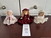 All three porcelain dolls displayed side by side