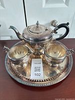 Full view of teapot, creamer, sugar bowl on tray