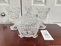 Full view of covered candy dish and two candle holders