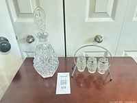 Full lot showing decanter, condiment stand with three jars
