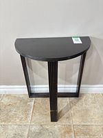 Full view of demi-lune table against wall