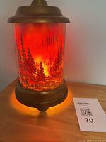 Lamp illuminated showing forest scene and glow