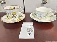 Both teacup and saucer sets side by side