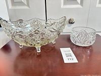 Large footed cut crystal bowl and smaller round bowl on table