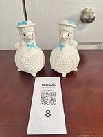 Front view of both porcelain poodle shakers