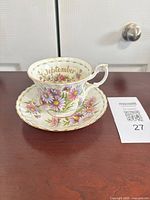 Cup on saucer showing pattern and September text