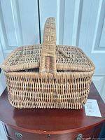 Side view of wicker picnic basket showing shape and handle