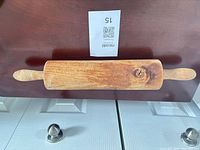 Front view of wooden rolling pin showing fixed handles