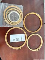 Bagged smaller hoops and three loose larger hoops on tabletop
