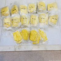 Multiple individually wrapped yellow gloves laid out